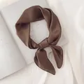 Vue détaillée d'un élégant foulard en satin marron foncé sur un fond minimaliste - Brun Foncé / 70cm