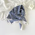 Detailed view of navy blue paisley silk scarf featuring intricate white cashew flower patterns. - Vintage Blue Paisley