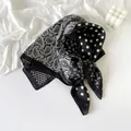 Detailed macro view of the black and white paisley and polka dot silk scarf texture - Polka Dot Black Paisley