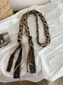 Detailopname van een Boheemse gevlochten katoenen riem met panterprint en kantdetails - Kanten Kralen Luipaard Stijl
