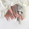Detail shot of elegant pink and white silk scarf with intricate paisley pattern - Pink Patchwork Paisley