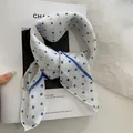 Elegant white square headscarf featuring blue polka dots and a striped border - 58x58cm / White with Blue Polka Dots