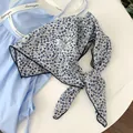Detailed view of blue floral print on white cotton square scarf with scalloped edge - Black Crochet Edge Scarf / Blue Leaves