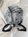 Detailed view of blue paisley silk scarf tied neatly on a white shirt background - 70cm / Blue and White Porcelain Paisley