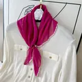 Detail view of a pleated fuchsia silk scarf with pink scalloped edges on a shirt. - 60CM / Plum Purple