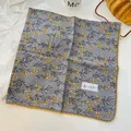 Macro view of gray cotton square scarf featuring yellow floral patterns and lace trim - Yellow Crochet Edge Scarf / Grey Plant