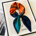 Elegant silk square scarf with orange and green floral pattern tied in a stylish bow - Orange Green Blue Contrast Scarf / Blue Orange Peony Print