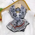 Elegant long printed silk-like scarf for women featuring a black meander pattern border - Greek Key