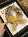 Stylish yellow and gray plaid cotton square scarf tied in a knot on a fashion book page - Retro Coffee Yellow Plaid