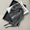 Detail shot of black and white patterned satin triangular scarf with silky texture - Multifunctional Bandana Scarf #01
