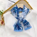 Elegant blue and white palm leaf print silk scarf displayed on a white dress - 35*140cm / Monstera Leaf