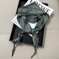 Close-up detail of green herringbone pattern satin neck scarf on magazine display - Multifunctional Bandana Scarf #02