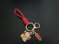 Handwoven red rope wristlet keychain featuring a lucky cat charm and golden hardware - Lucky Cat (Fortune) / Red