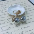 Cute metallic cherry keychain featuring chrome silver fruit and elegant gold-tone leaf charm - Silver