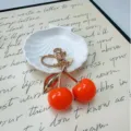 Cute simulated orange cherry keychain charm with golden stem and leaf for bags and gift - Orange