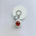 Gothic style keychain featuring an orange horror eyeball and silver heart charm - White Ball Red Eye
