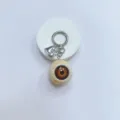 Gothic horror realistic brown eyeball keychain with silver heart charm on a white background. - Cream Ball Brown Eye