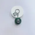 Gothic style keychain featuring a green marble eyeball pendant and silver heart charm - Green Ball Grey Eye