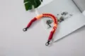 Hand-woven red and orange phone wrist strap with durable black metal clasps accessory - Fish Mouth Clasp with Tether Pad / Red And Orange
