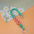 Hand-woven daisy wrist strap phone lanyard in vibrant green and pink floral design - Spring Ring and Patch Style / Green + Pink