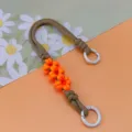 Handmade orange daisy braided phone wrist strap with khaki cord and white circular rings - Spring Ring and Patch Style / Brown and Orange