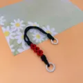 Braided daisy phone wrist strap in black and red with white rings - Spring Ring and Patch Style / Black + Red