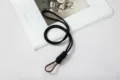 Black hand-woven paracord lanyard with a brown metal carabiner hook for keys. - Black Cord With Brown Clip And PVC Pad / Black