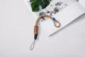 Durable braided paracord wrist lanyard for phone and camera in tactical khaki color - Braided Style (Buckle + Button) / Brown Pattern