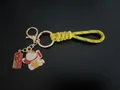 Handmade yellow braided rope keychain featuring a Maneki-neko lucky cat charm and tag - Lucky Cat (Peace Joy) / Yellow