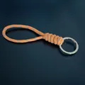 Durable orange braided paracord keychain with reflective threads and silver metal ring - Orange