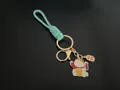 Handwoven mint green rope keychain featuring a gold-tone lucky cat charm for bags - Emerald Green
