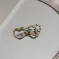 Detail of rhinestone heart-shaped hair clip with colorful crystals on a mirror. - Heart Glasses Shape (Colored Rhinestone)