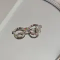 Macro view of a silver-toned glasses-shaped hair clip adorned with colorful rhinestones - Round Glasses Shape (Colored Rhinestone)