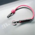 Braided phone wrist strap in pink and gray paracord with a metal ring and clear gasket - Light Gray & Pink