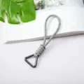 Gray braided paracord wrist strap with triangular metal carabiner hook for outdoor use. - Gray