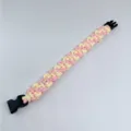 Pink and cream braided paracord survival bracelet with black plastic buckle closure - Pink + Light Yellow
