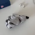 Close-up of elegant silver satin pleated banana clip with white polka dots for women - Gray Polka Dot - Ruffled Banana Clip