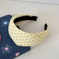 Gros plan d'un serre-tête rembourré jaune crème avec motif d'étoiles mignon - Style Étoile Large / Jaune