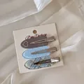 Set of three Korean style acrylic hair clips with heart and plaid patterns on a card - Three-Piece Set / Blue Gray