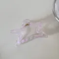 Detalle de una pinza para el cabello en forma de estrella con cuadros rosas y claros. - Cuadros Rosas-Pinza Estrella