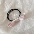 Close-up detail of a light pink fabric double bow hair tie on white background. - Light Pink