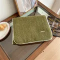 Close-up of olive green mohair scarf with decorative white whipstitch edges and logo tag - 160cm / Green Leaves