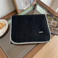 Detailed view of a soft black mohair cashmere scarf featuring white blanket stitch edges. - 160cm / Black