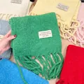 Detailed view of colorful bouclé wool blend scarves featuring a stylish patch label - 222cm / Vintage Green