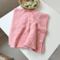 Close-up detail of a soft pink knitted wool scarf featuring a delicate openwork pattern - Rose Pink / 170cm