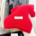 Detail of bright red 100% wool knitted scarf showing the fabric label and texture - Red / 165cm
