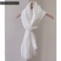 Detail view of a minimalist pure white cotton linen scarf with elegant frayed edges - 180cm / Pure White