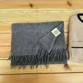 Close-up detail of a soft grey 100% Australian wool scarf featuring elegant fringe tassels - Charcoal Gray