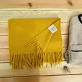 Yellow 100% Australian wool scarf with tassels on wooden background - Ginger Yellow