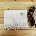Premium 100% Australian wool scarf in light beige featuring soft fringe details - Oatmeal